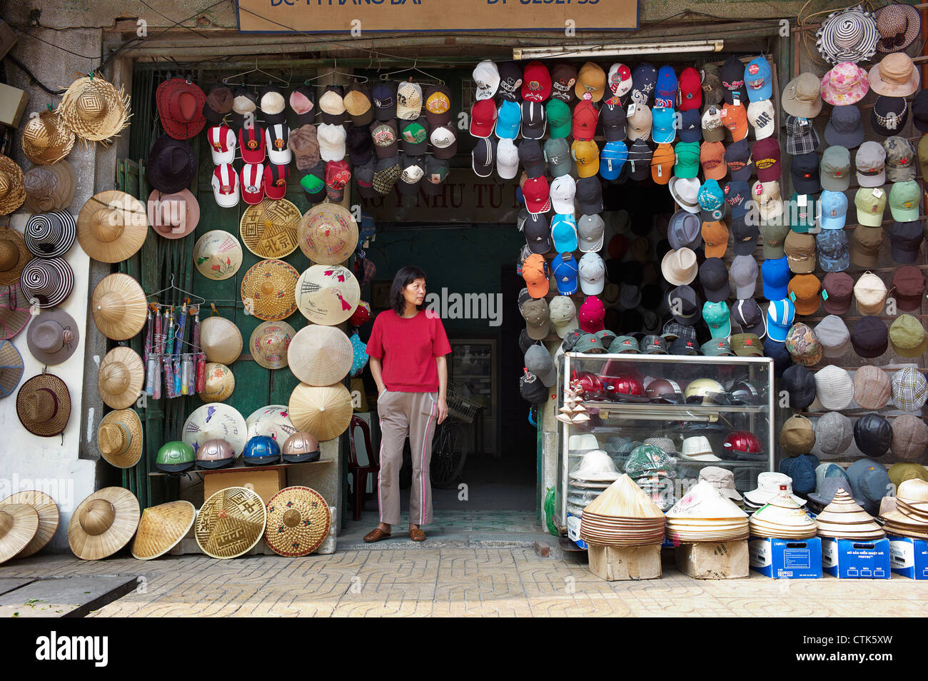A street vendor selling a variety of modern and traditional hats Stock