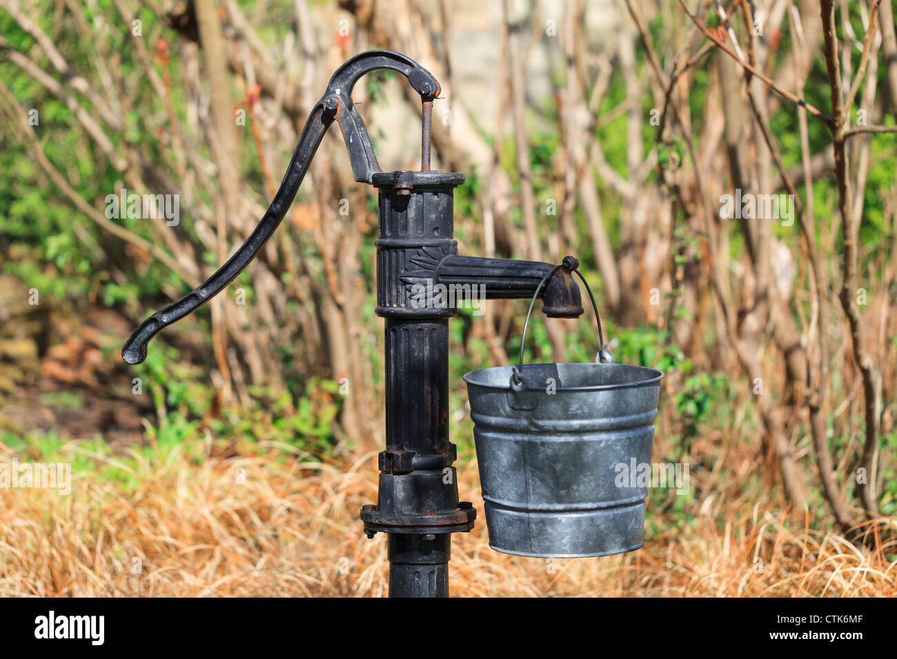Old Water Pump and metal bucket Stock Photo Alamy