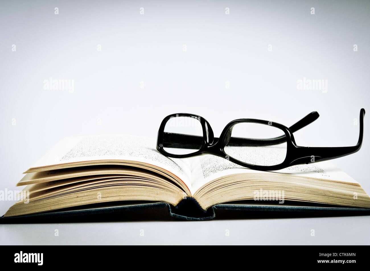 reading glasses on an open book Stock Photo