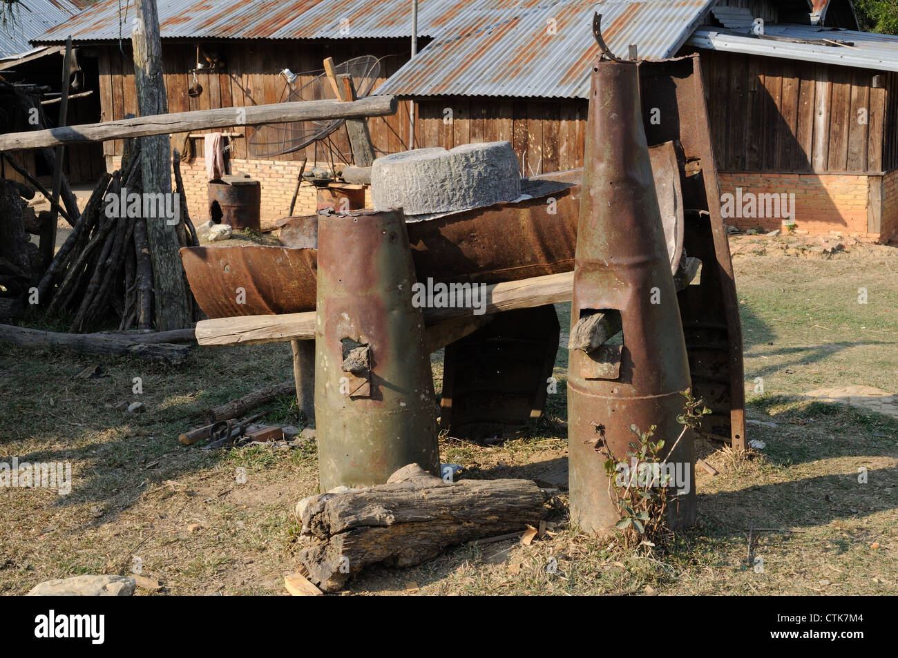 A rice mill made from American war bomb shells at a Hmong Village laos Stock Photo