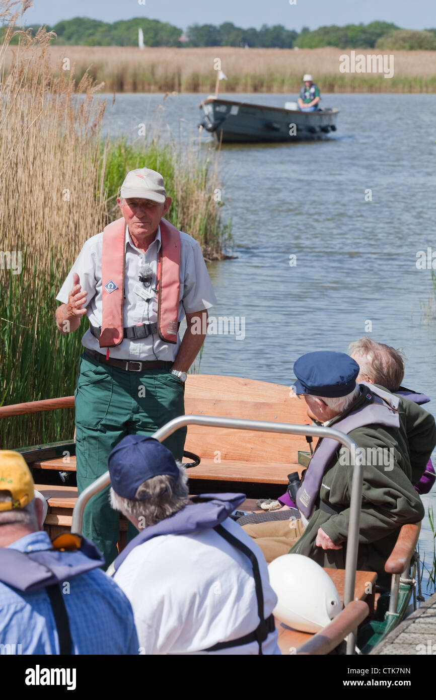 Norfolk Wildlife Trust. Water Trail Guide and electric boats, with visitors on board. Hickling Broad Nature Reserve. Norfolk NNR Stock Photo