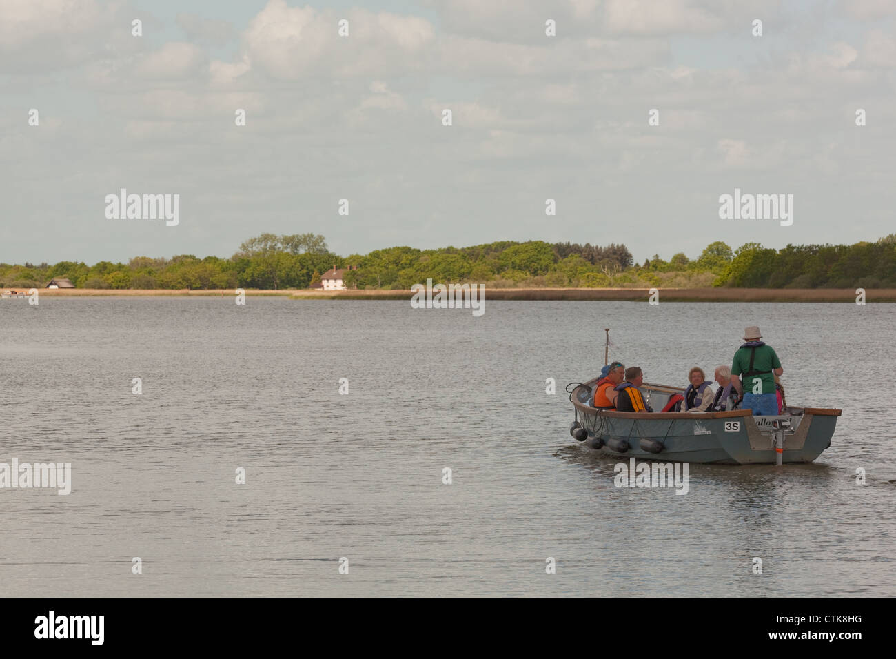 Norfolk Wildlife Trust Water Trail Guide and electric boat, 'Swallowtail', with visitors on board. Hickling Broad Nature Reserve Stock Photo