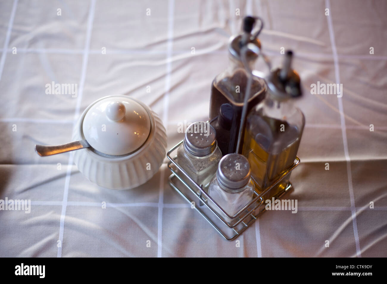 Table ready for a rustic breakfast with salt, pepper, oil, vinegar and