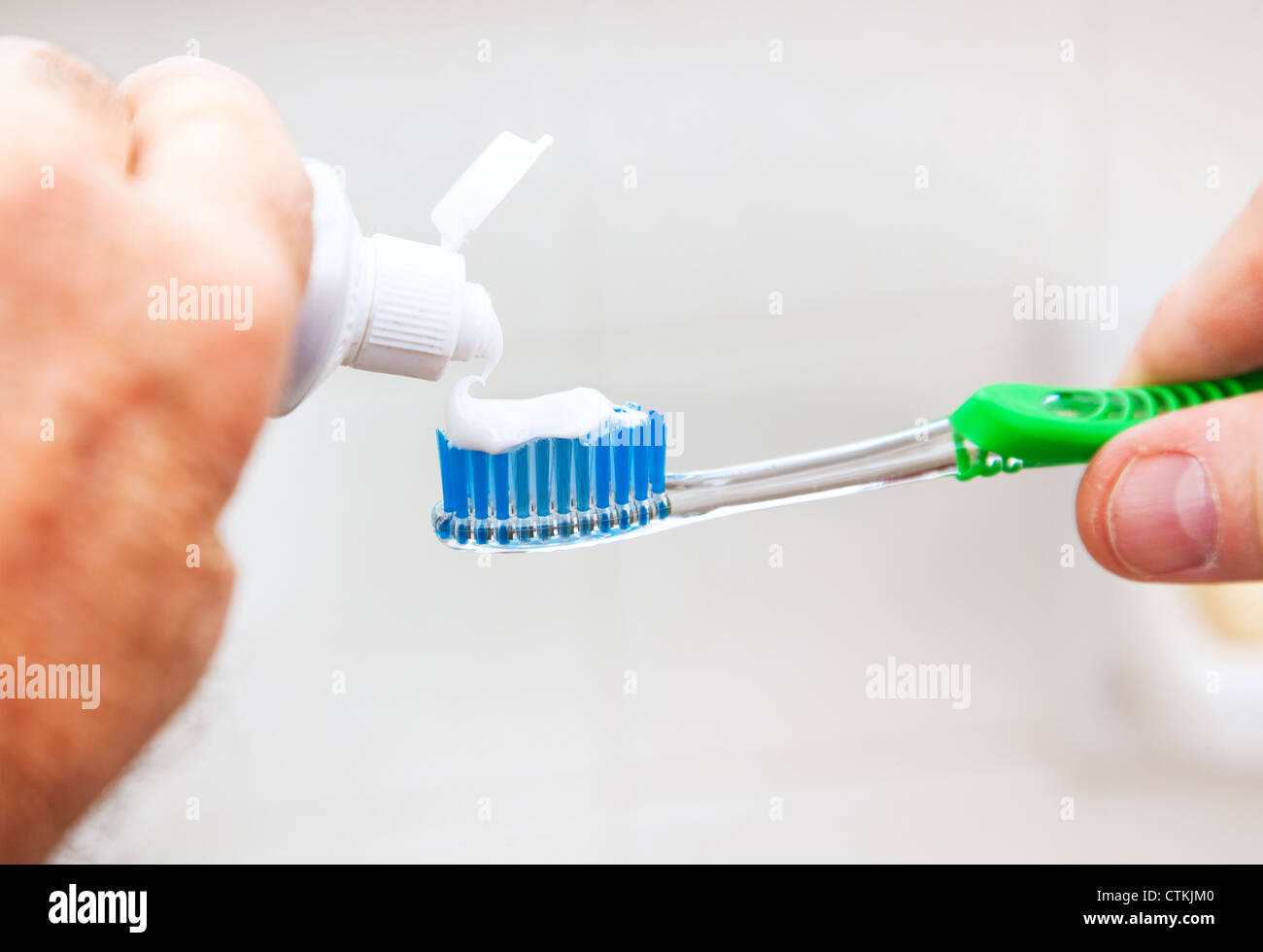 Man's hand putting toothpaste on his tooth brush Stock Photo Alamy