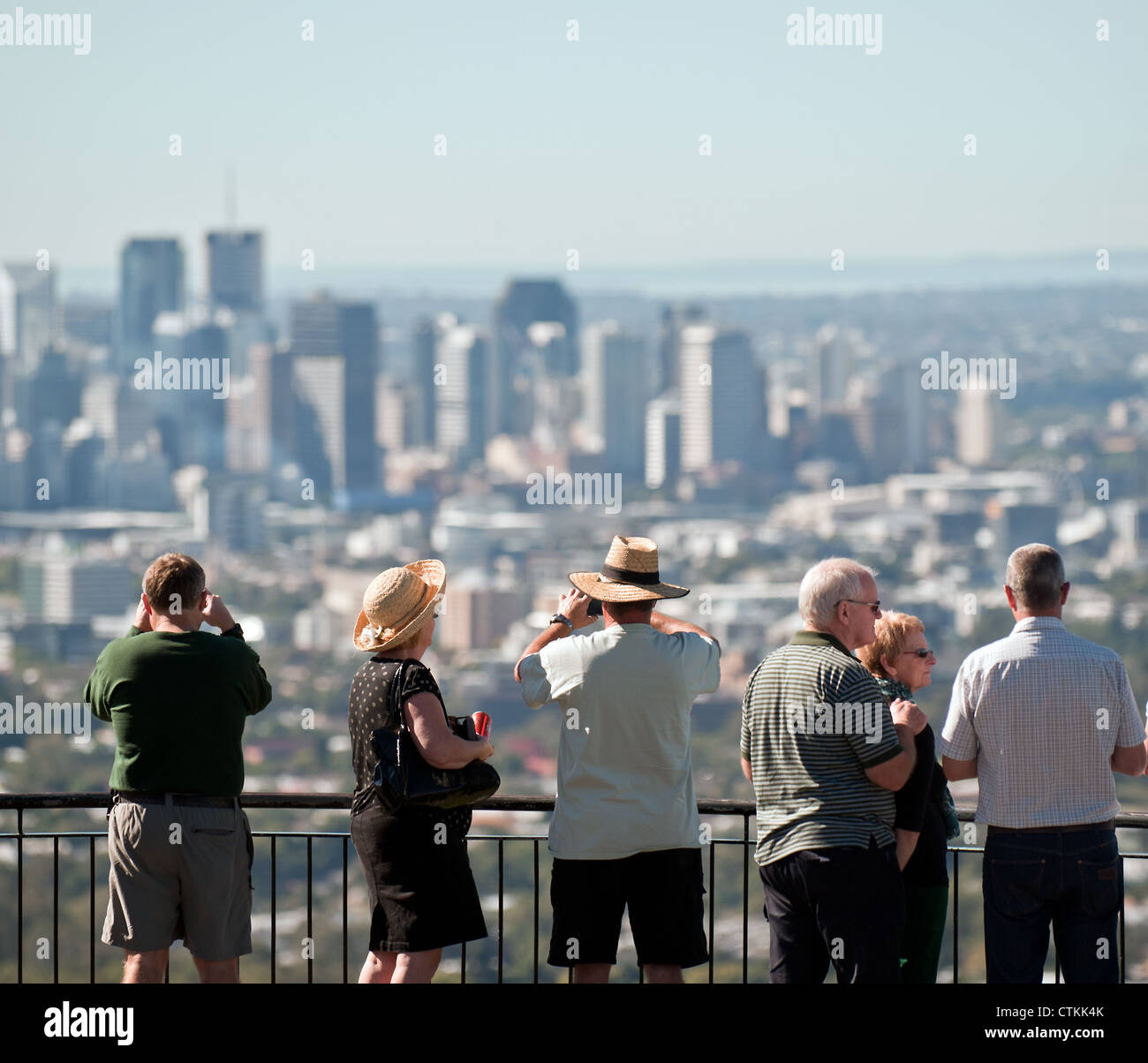 Tourists looking out over the City of Brisbane from the summit of Mt Cooth-Ta Stock Photo