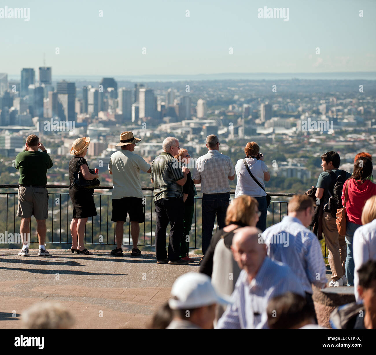 Tourists looking out over the City of Brisbane from the summit of Mt Cooth-Ta Stock Photo