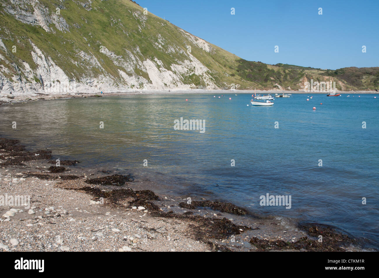 sea cove bay low tide sunny shingle beach Stock Photo