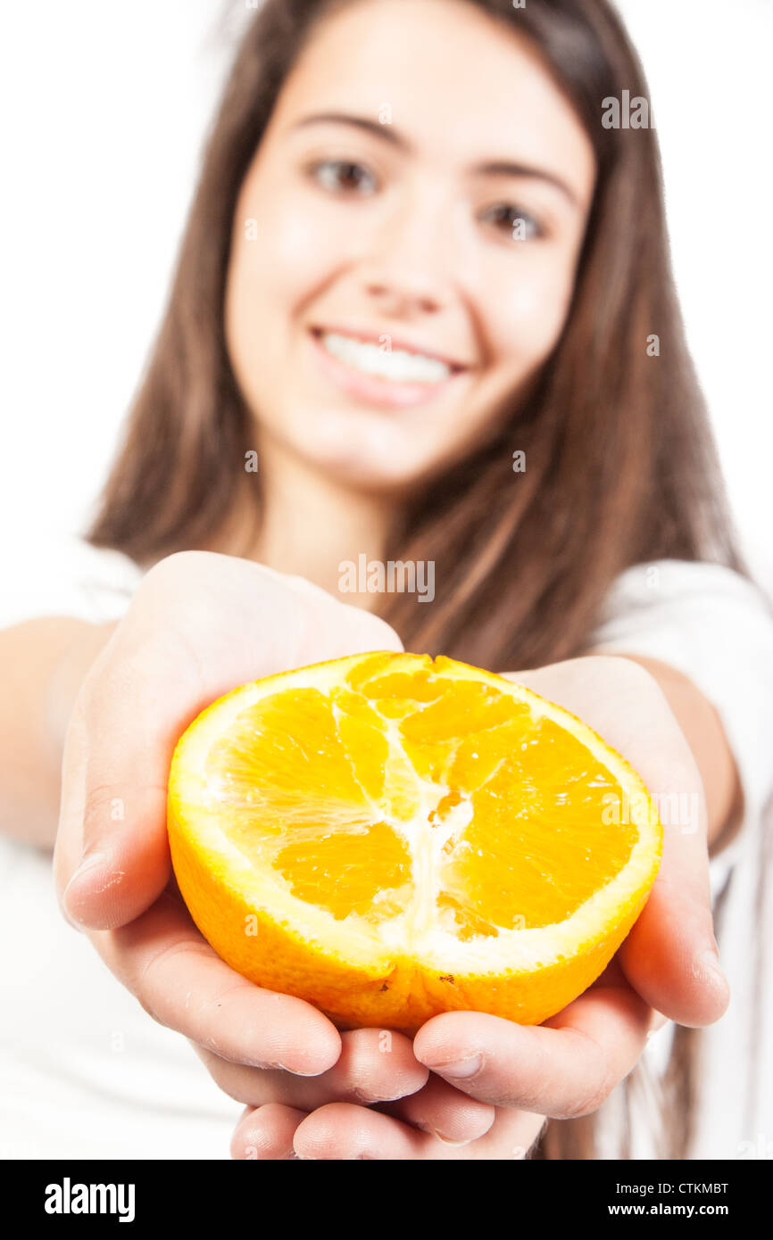 Young woman holding a orange Stock Photo - Alamy