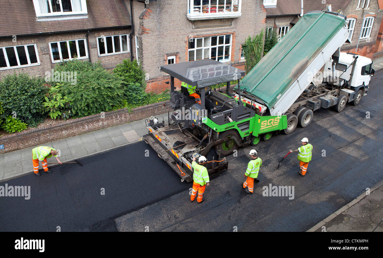 Road being resurfaced with new layer of tarmac asphalt Stock Photo