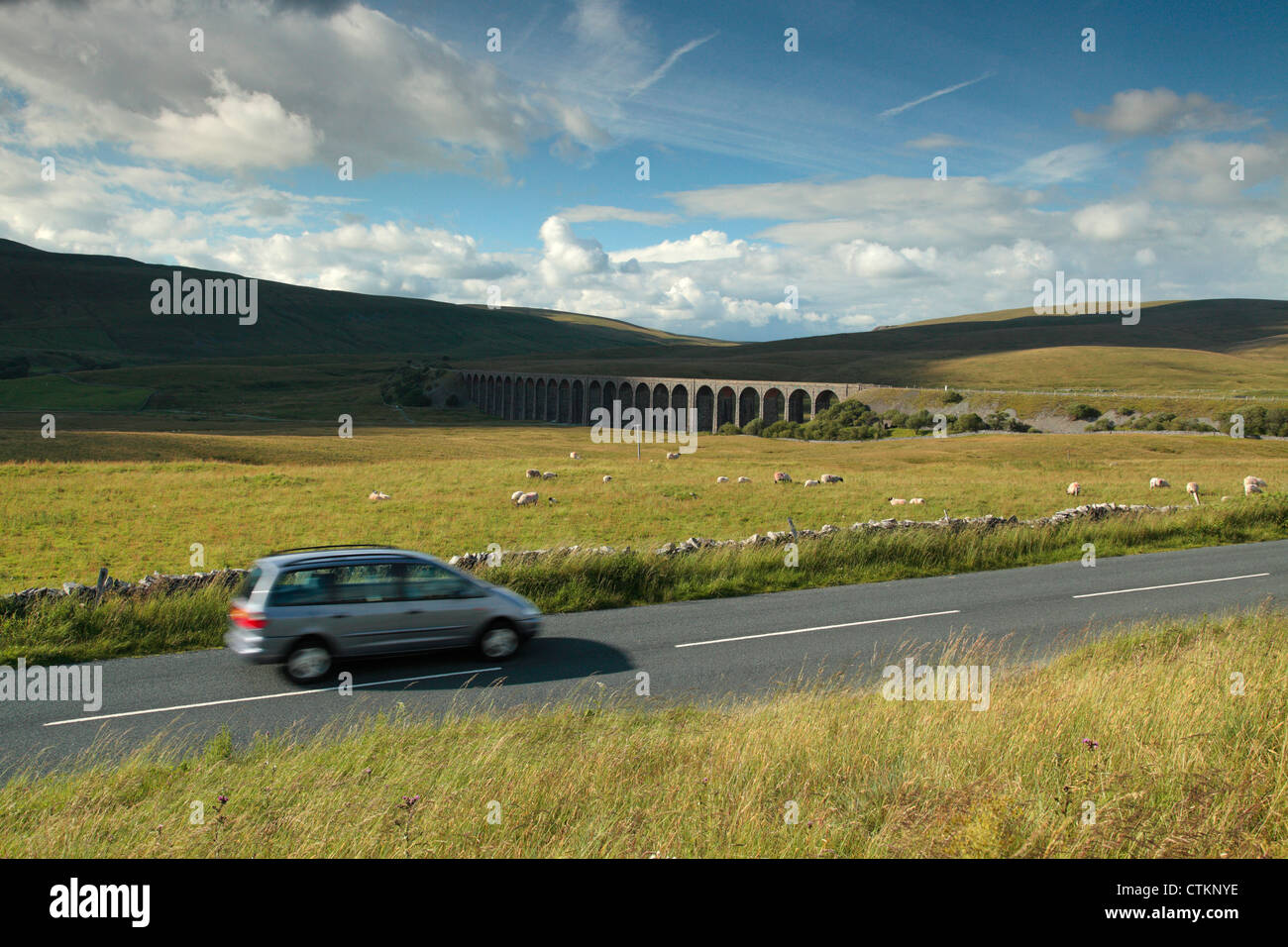 Car driving past Ribblehead Viaduct in the Yorkshire Dales of England Stock Photo