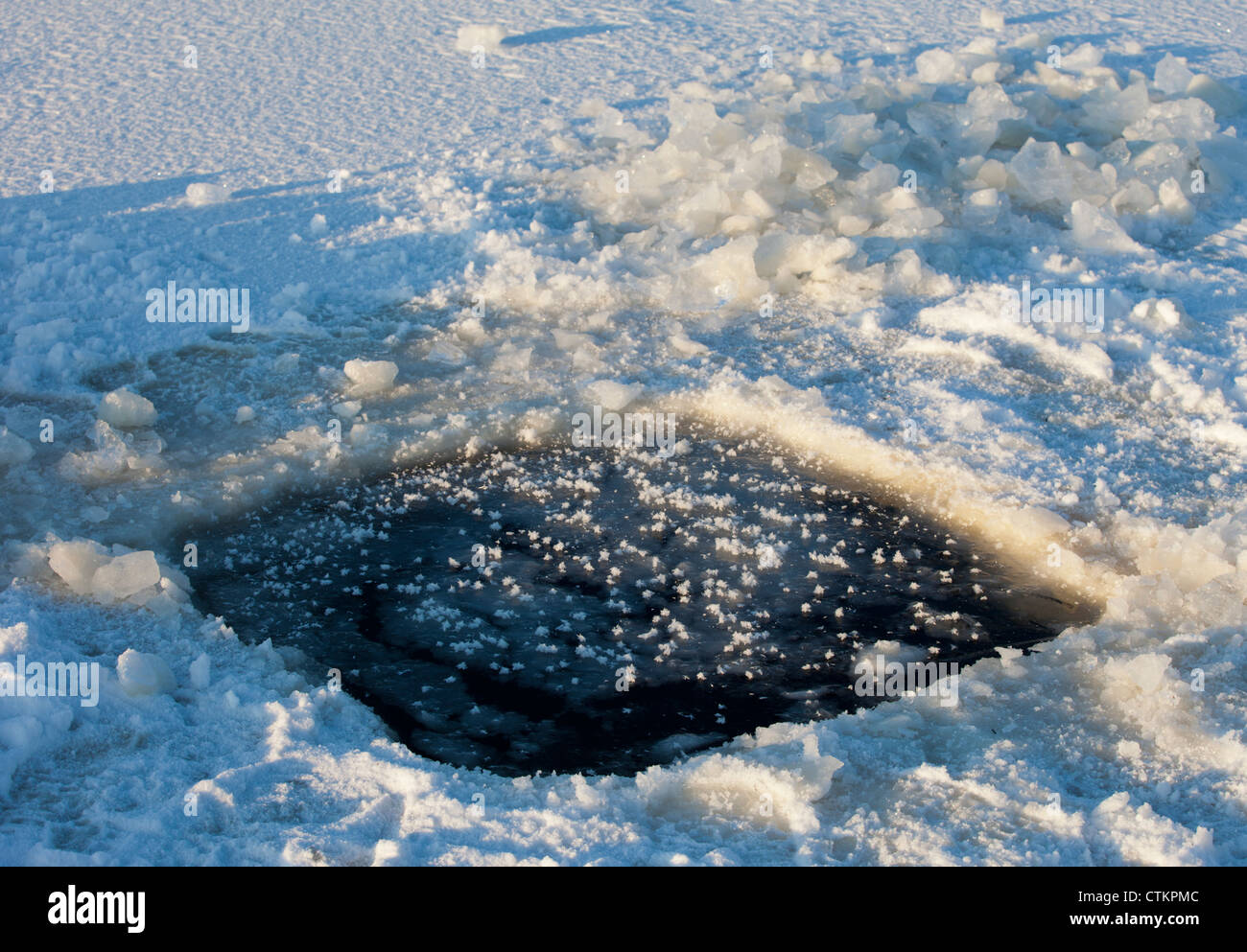 Isolated closeup of a rectangular hole in the ice. Used for inserting