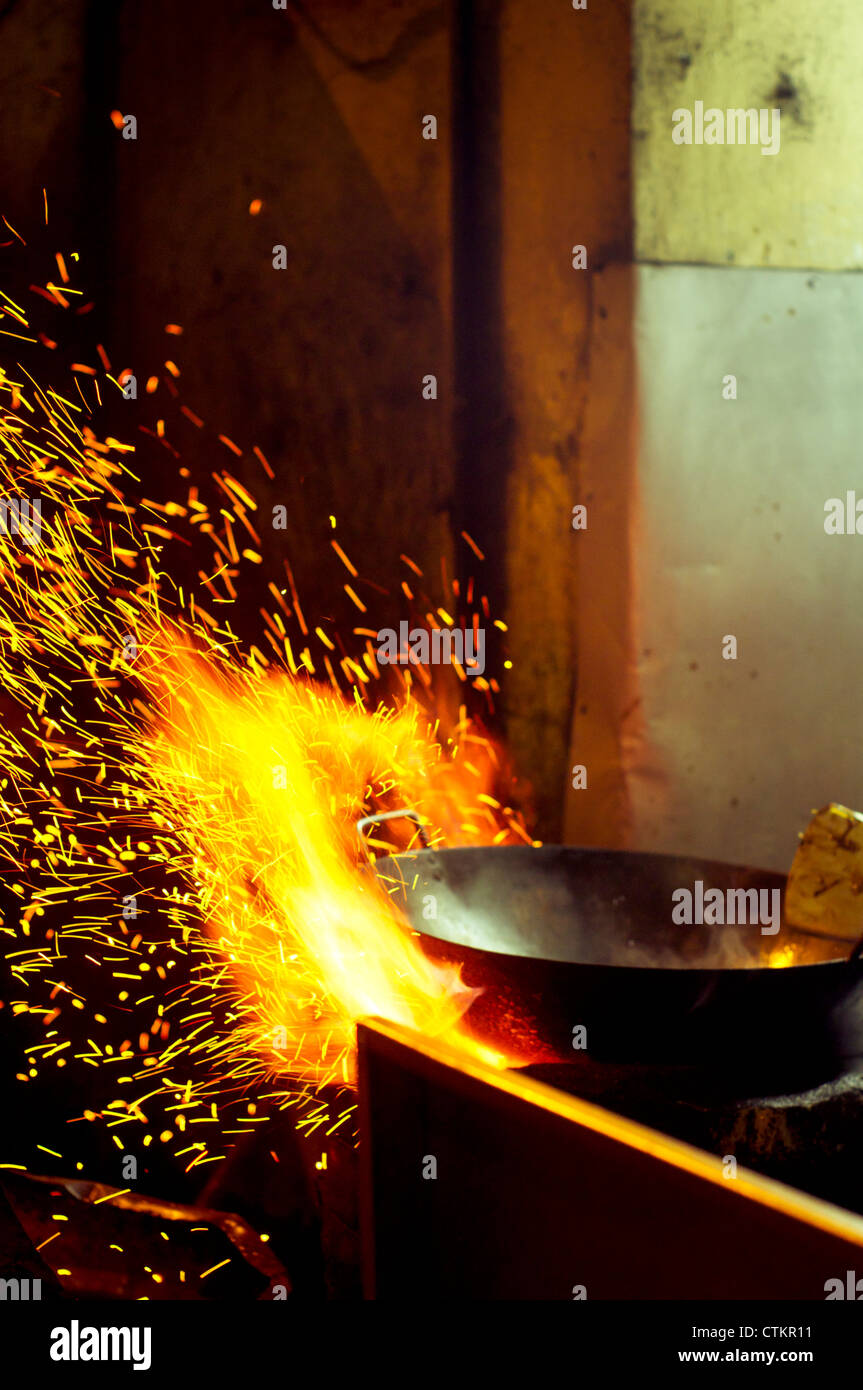 wok cooking in asian style, common scene at the street in asian