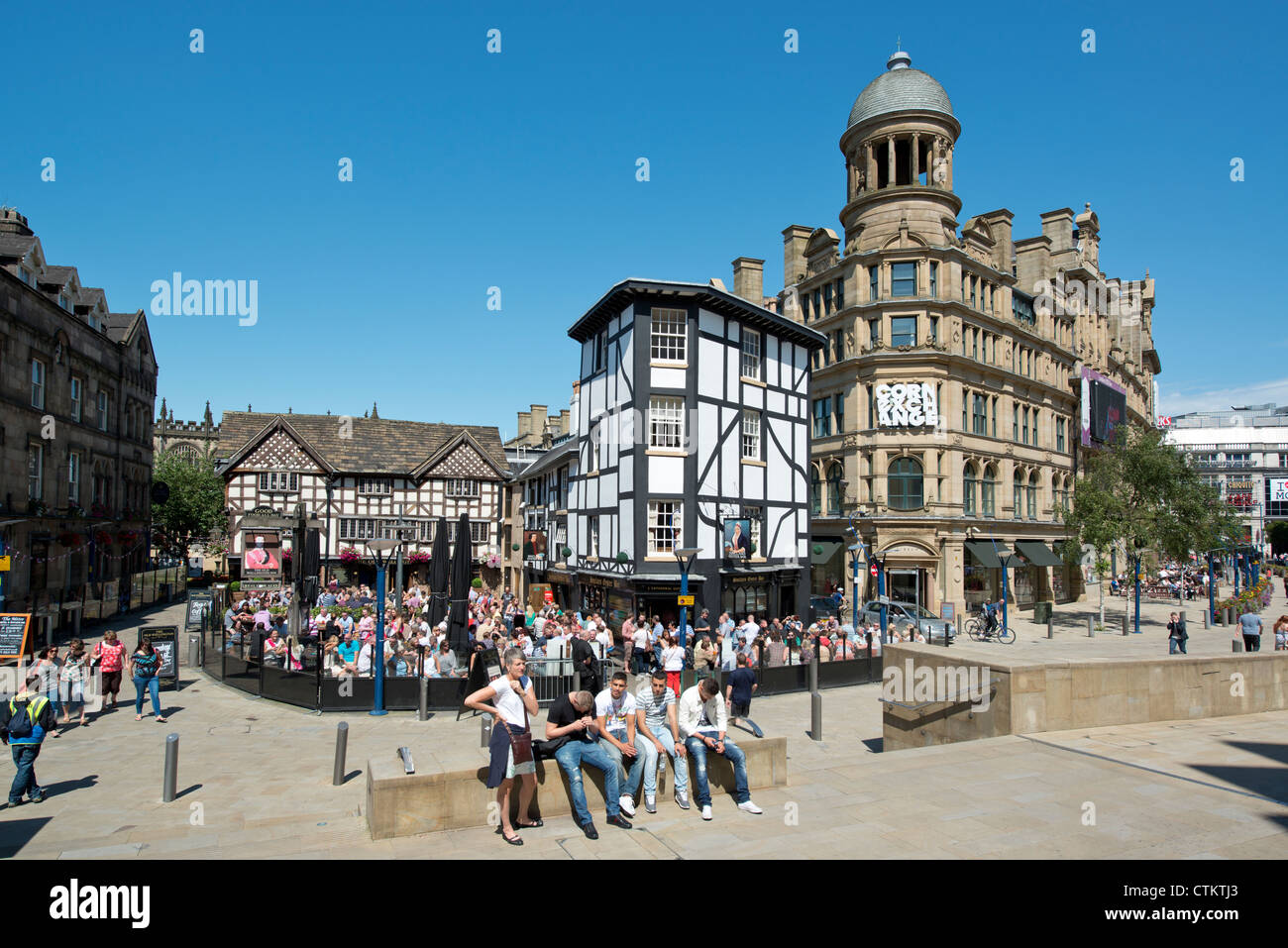People enjoy themselves in beer garden of Sinclair's Oyster Bar near Corn Exchange Triangle in Manchester. Stock Photo
