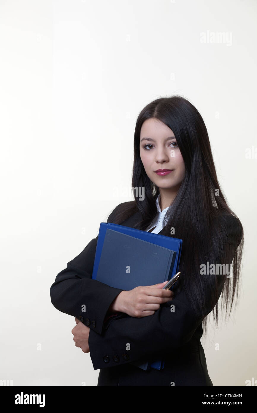 standing young business woman holding documents Stock Photo - Alamy