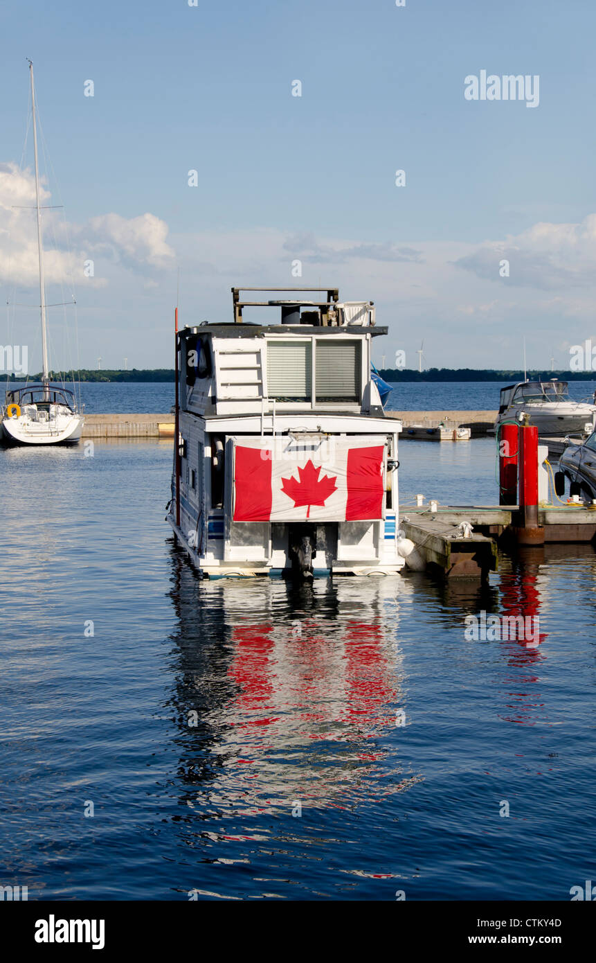 Canada, Ontario, Kingston. Lake Ontario marina area at the port of Kingston. Boat with flag. Stock Photo