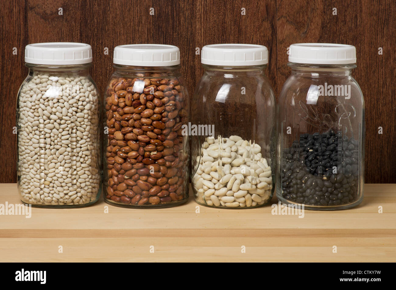 Dry beans stored in glass canisters in the kitchen Stock Photo Alamy