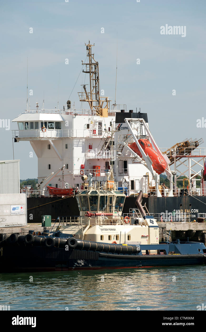 Port of Southampton England UK Sand Falcon and a tug alongside Stock Photo