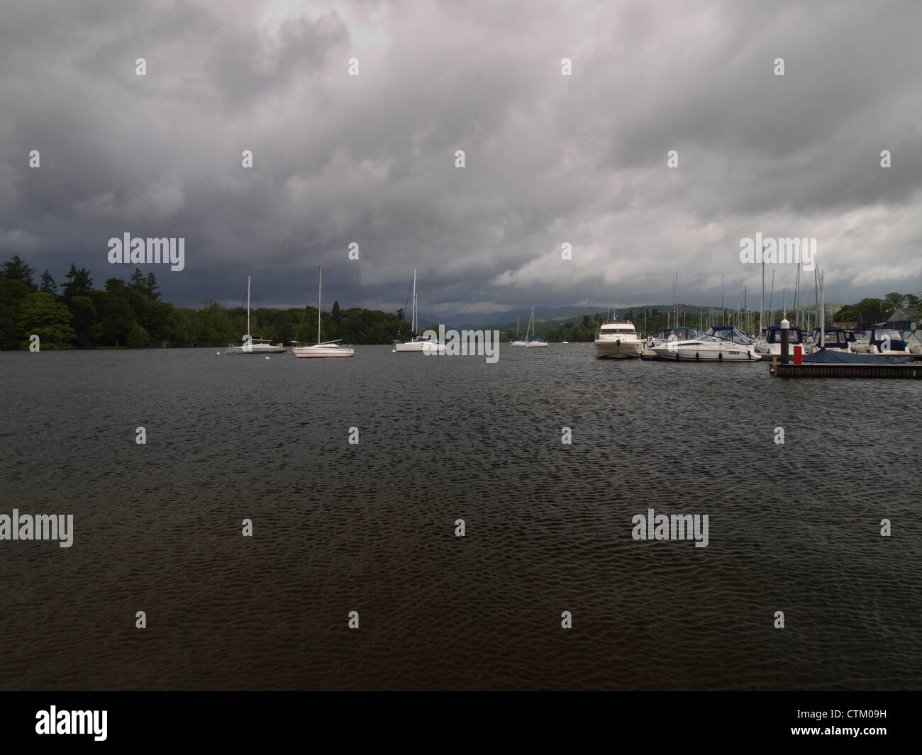 Boats on Windermere under stormy skies Stock Photo Alamy