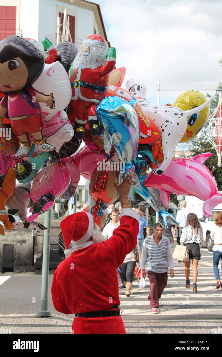 Madeiran balloon seller at Christmas, Funchal Stock Photo