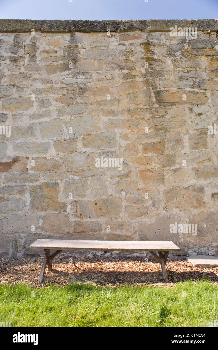 A lonely bench in the courtyard of the Women's Ward, at the Old Idaho State Penitentiary, Boise, Idaho, USA. Stock Photo