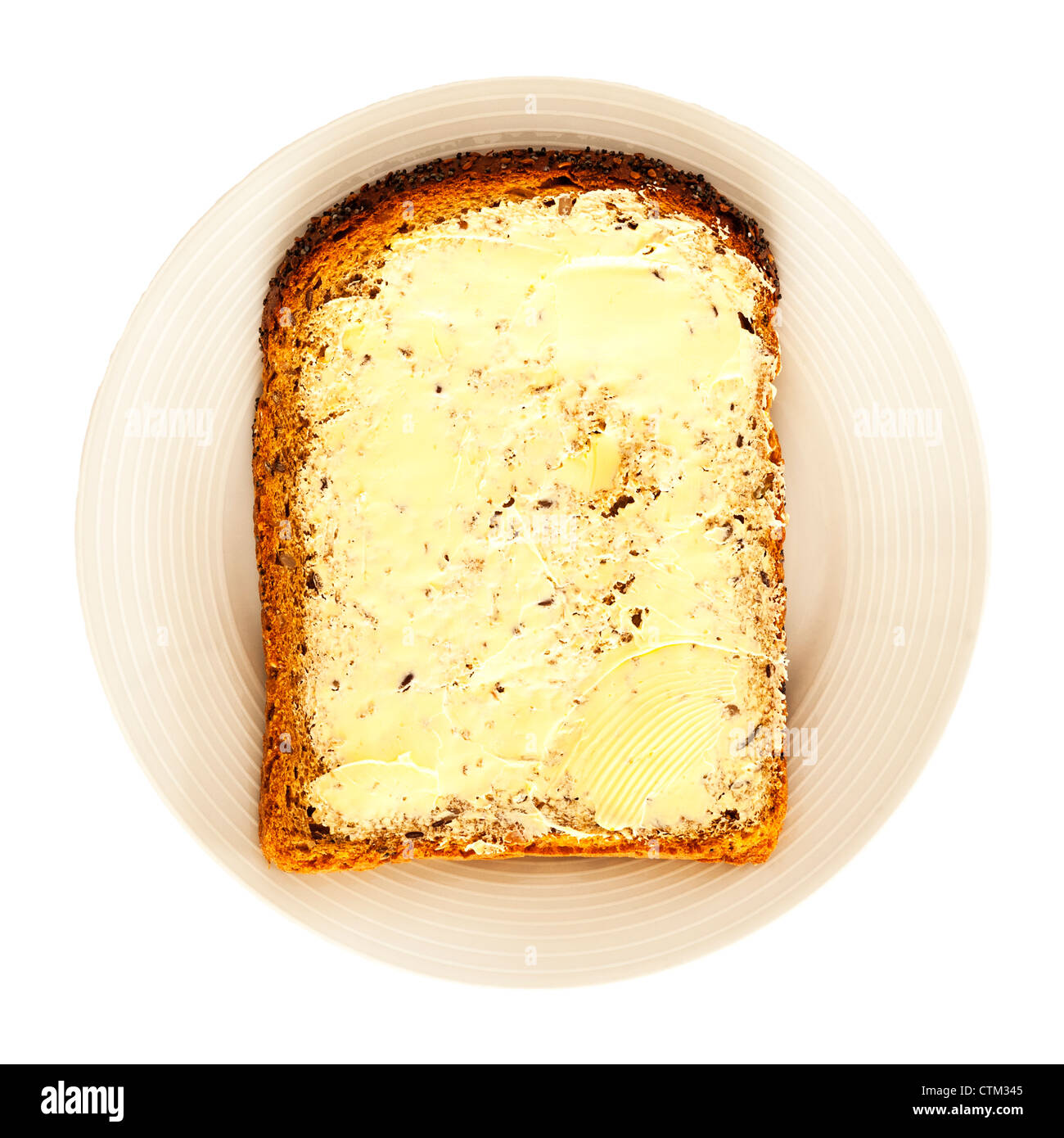 A slice of seeded bread and butter on a white background Stock Photo ...