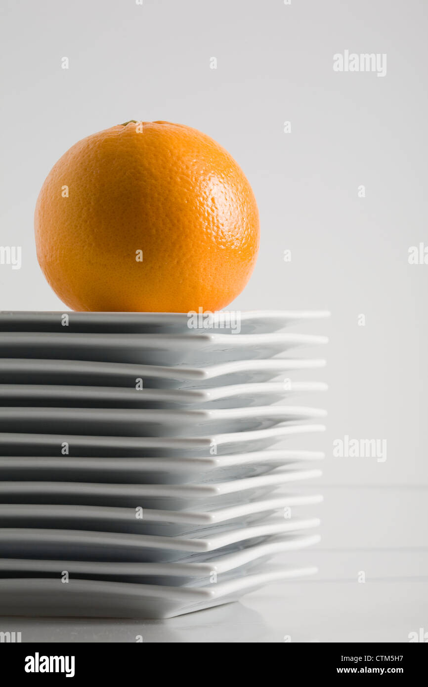 Stack Of White Square Plates With An Orange On Top On A White Stock ... Stack Of White Square Plates With An Orange On Top On A White Stock ...