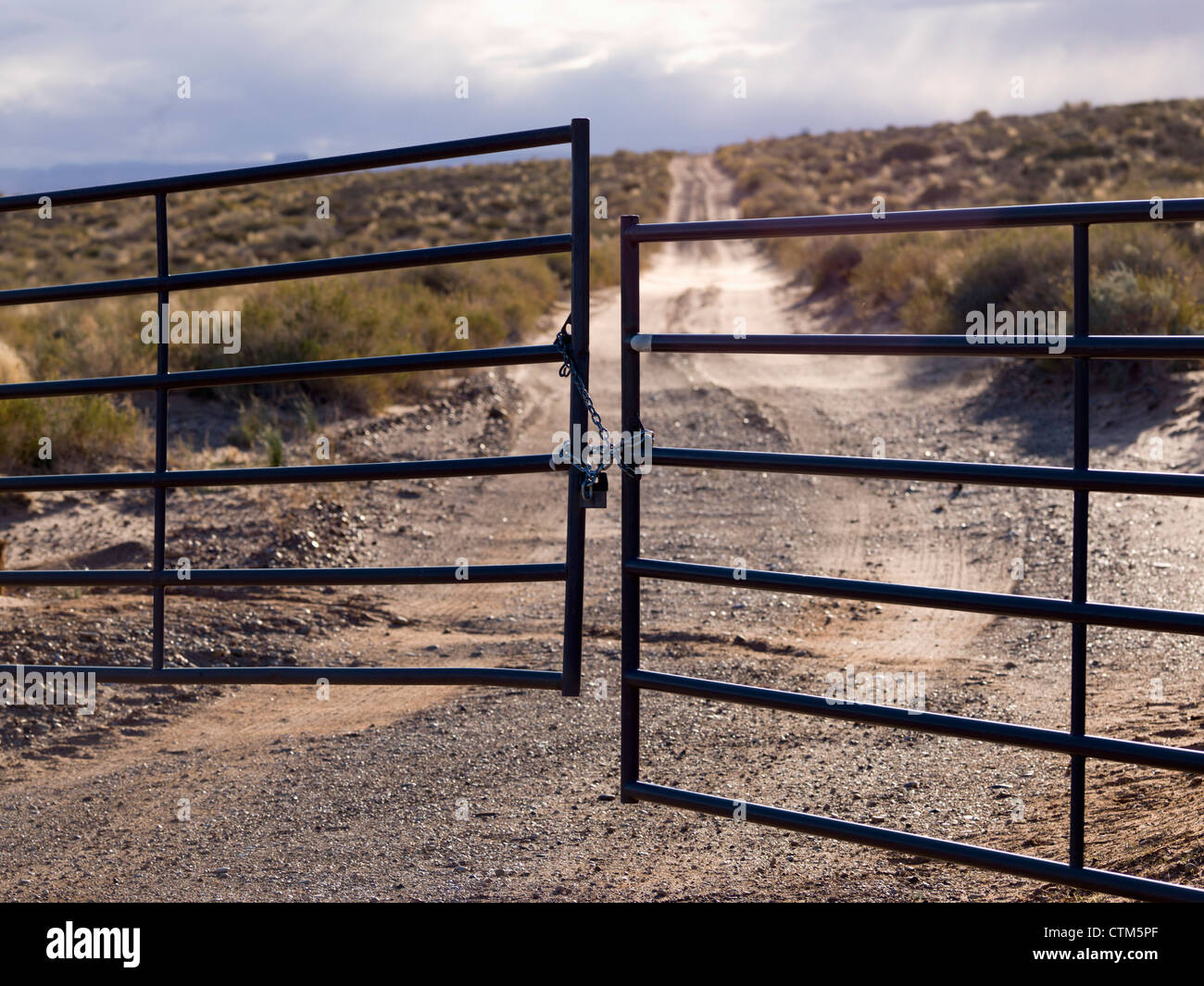 Metal Gate Locked On A Dirt Road In Glen Canyon National Recreation Area; Utah, United States of America Stock Photo