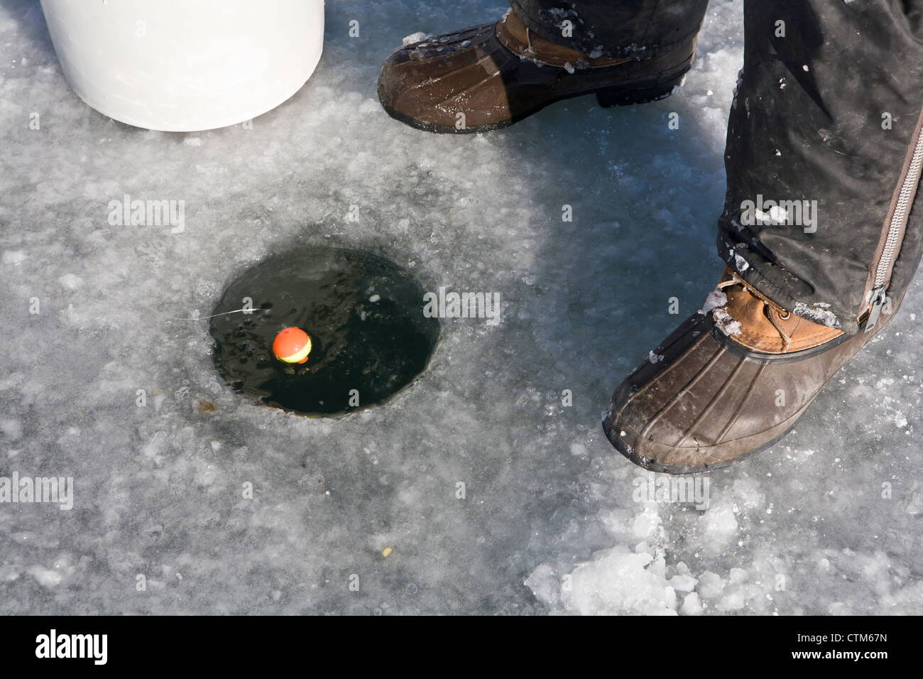 Bobber in a Hole in the Ice Stock Photo - Image of cracksinice,  winterfishing: 58142772