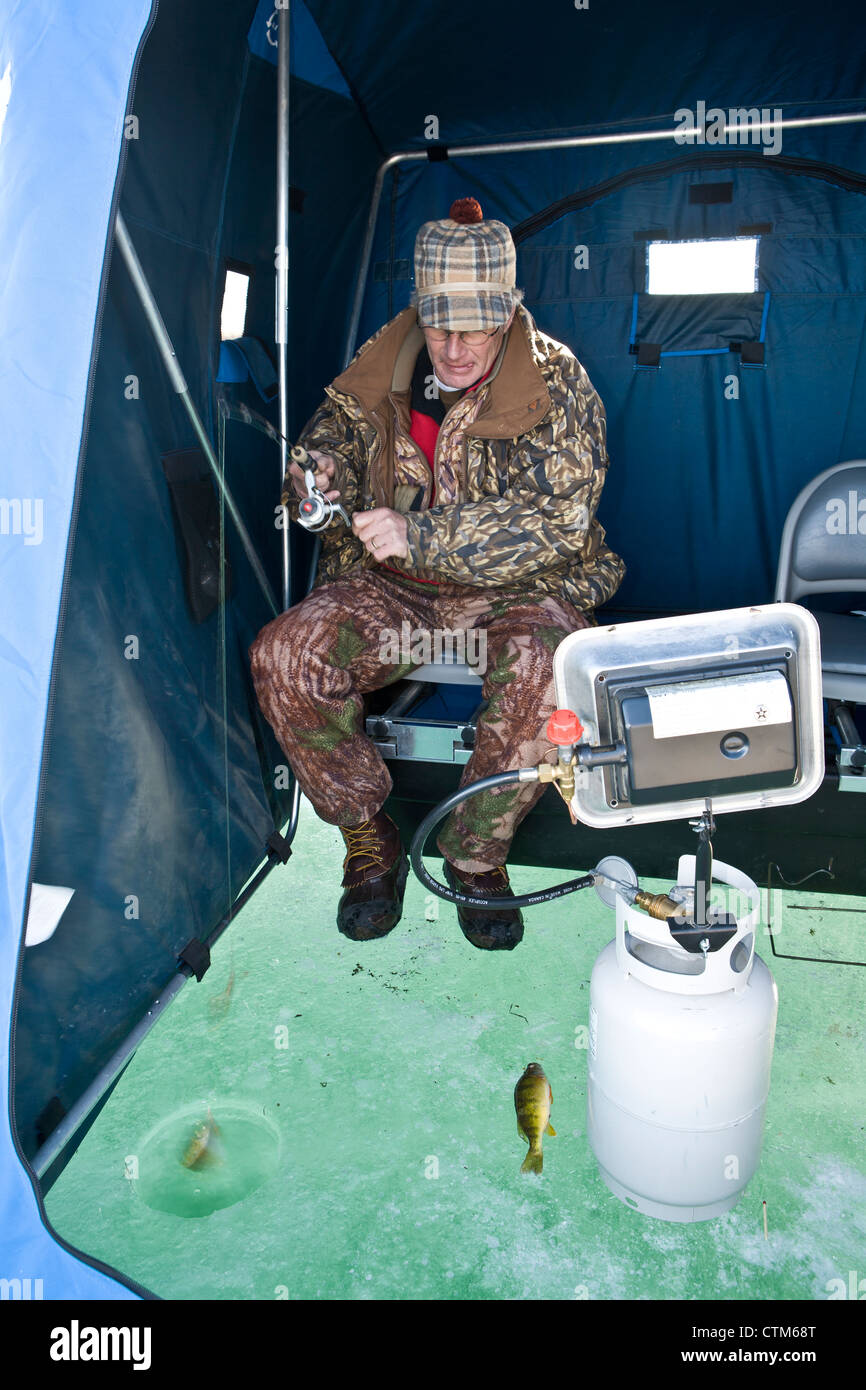An ice fishing house, a propane heater and biting perch Stock