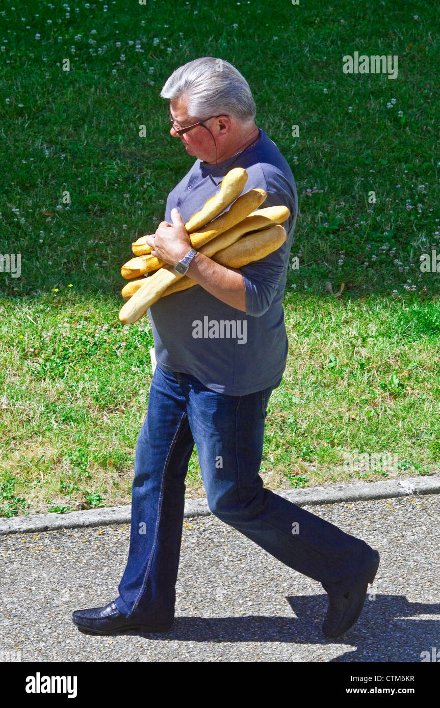 Man carrying four baguettes France Stock Photo Alamy