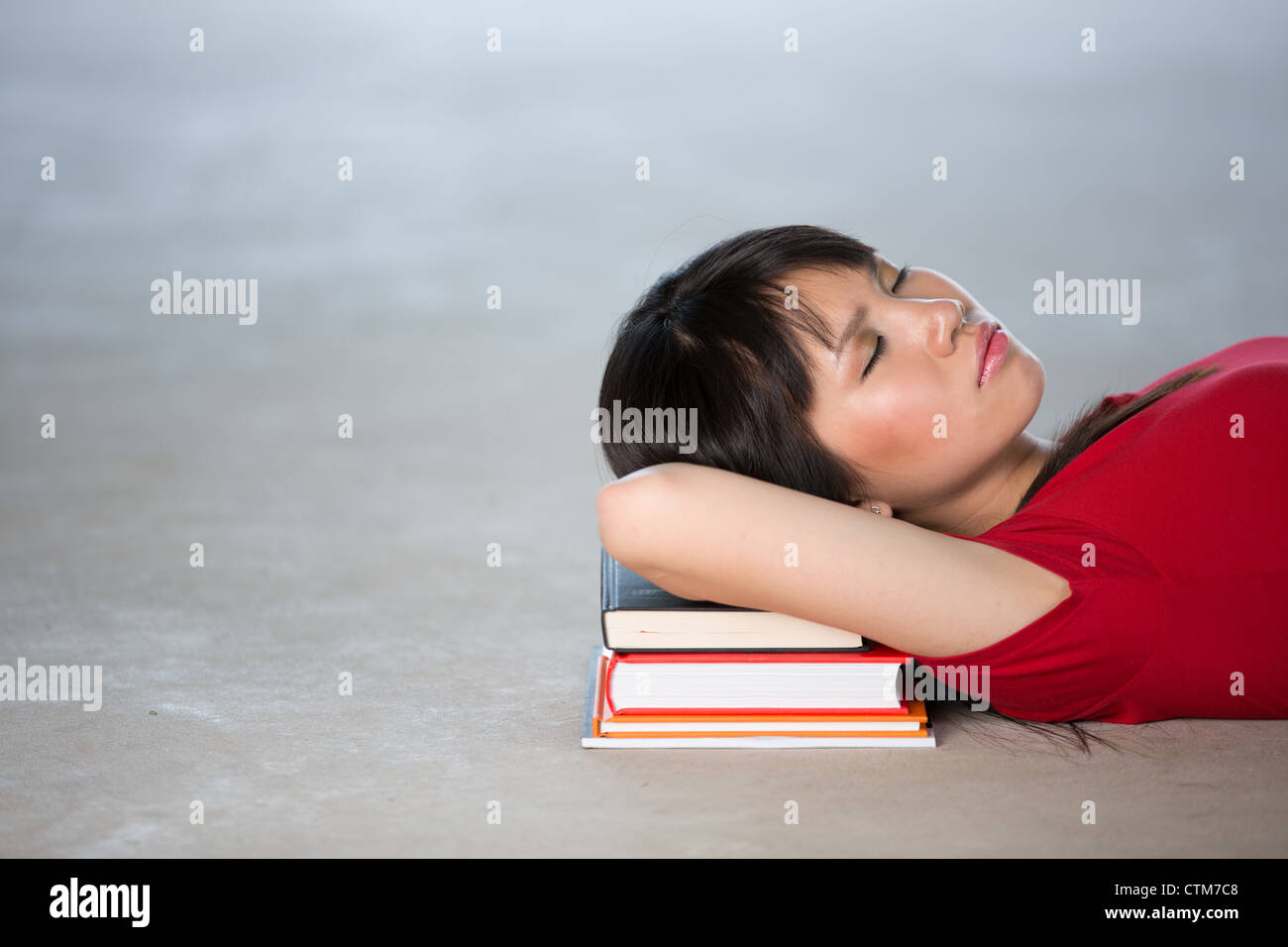 Female College Student Sleeping on pile of books Stock Photo - Alamy