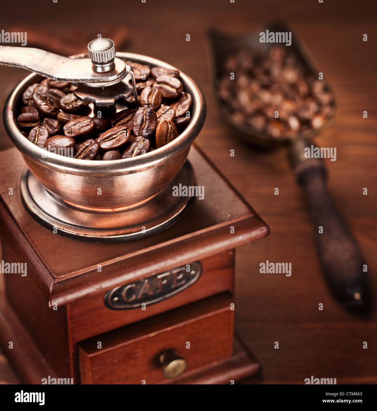 Roasted coffee beans are ground in a coffee grinder Stock Photo - Alamy