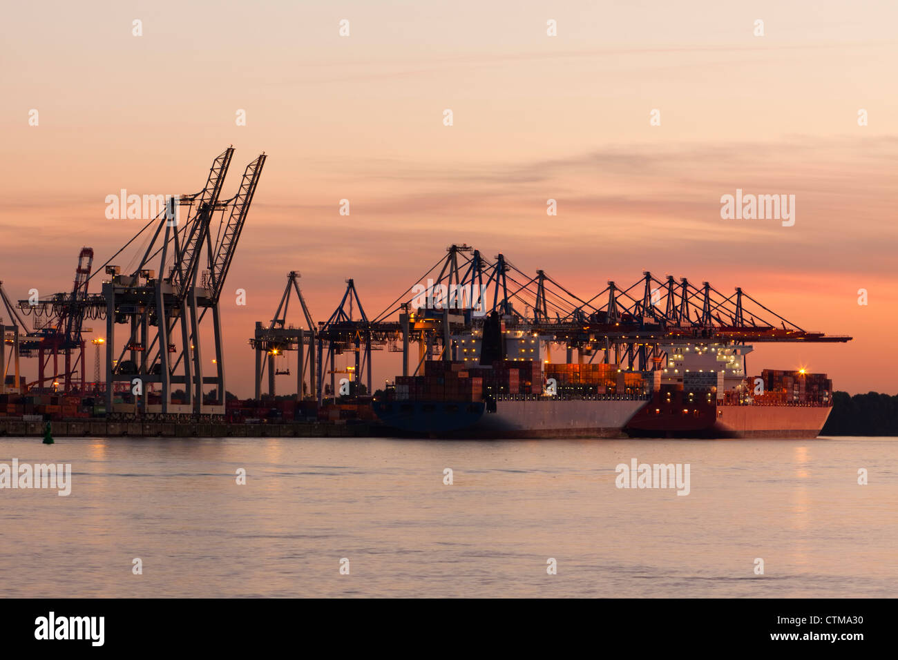 Burchardkai Container Terminal at Hamburg harbor in sunset Stock Photo