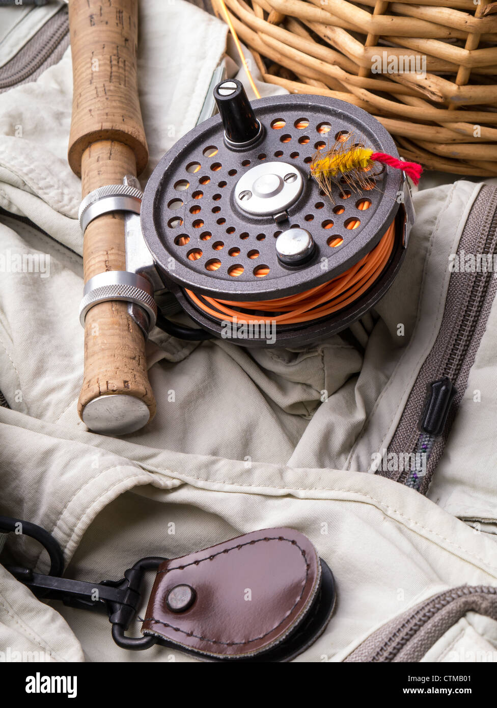Fly fishing still life with rod, reel, creel and vest. Stock Photo
