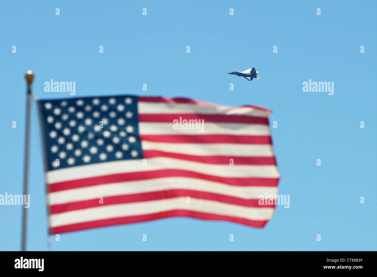 F-22 Raptor fighter jet flying behind an american flag Stock Photo