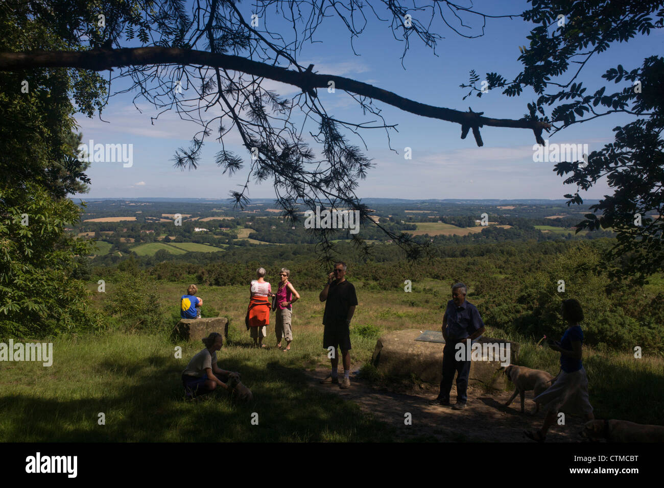 Walkers gather at Gills Lap in Ashdown Forest, 1600 hectares of Heathland used by AA Milne in Winnie the Pooh's 100 Acre Wood. Stock Photo