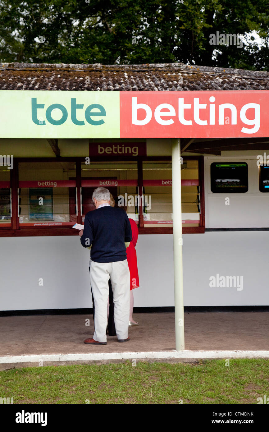 People betting on the horses at Tote betting on race night, Newmarket  Racecourse Suffolk UK Stock Photo - Alamy