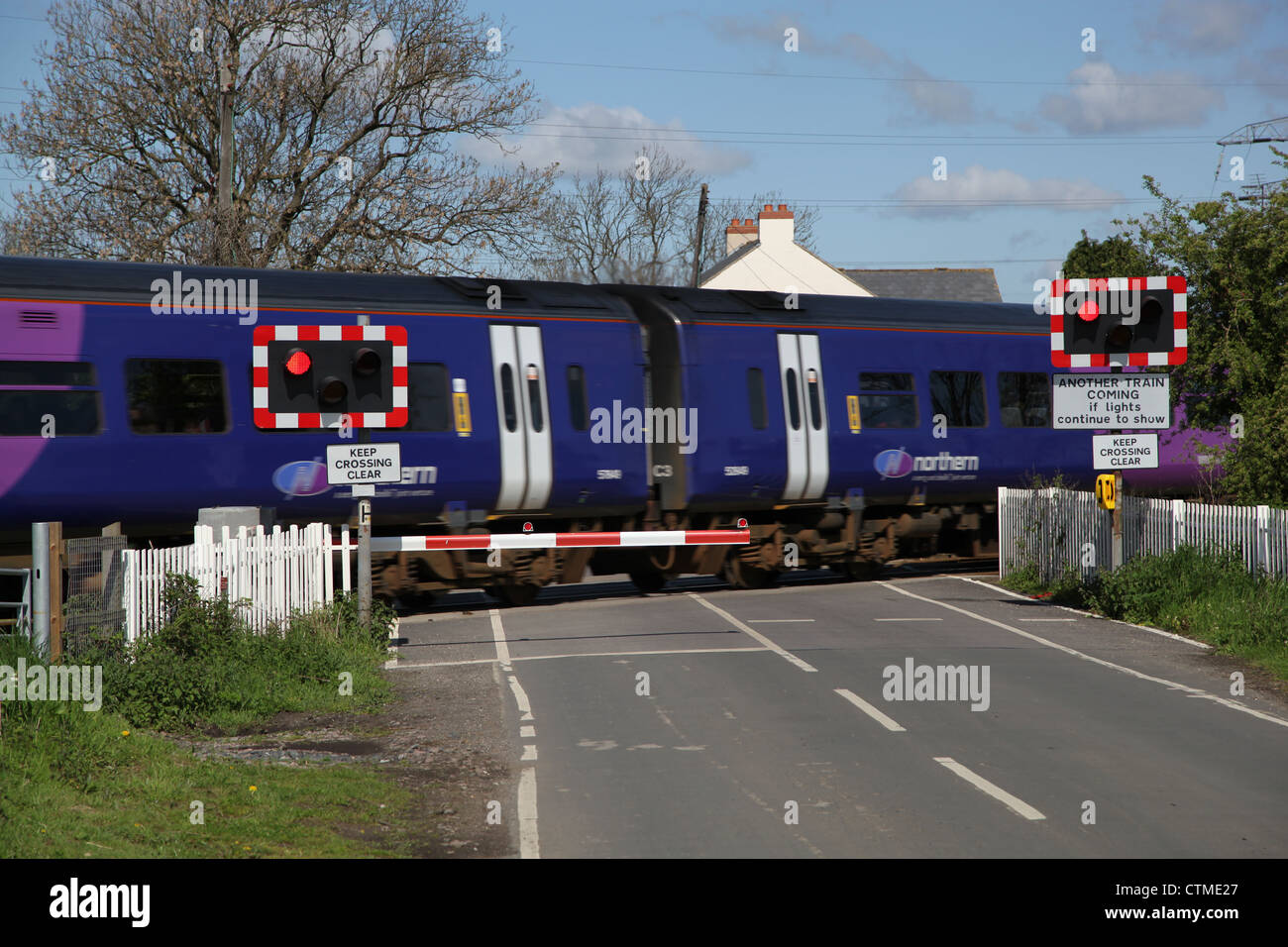 half barrier railway crossing, train crossing country road Stock Photo
