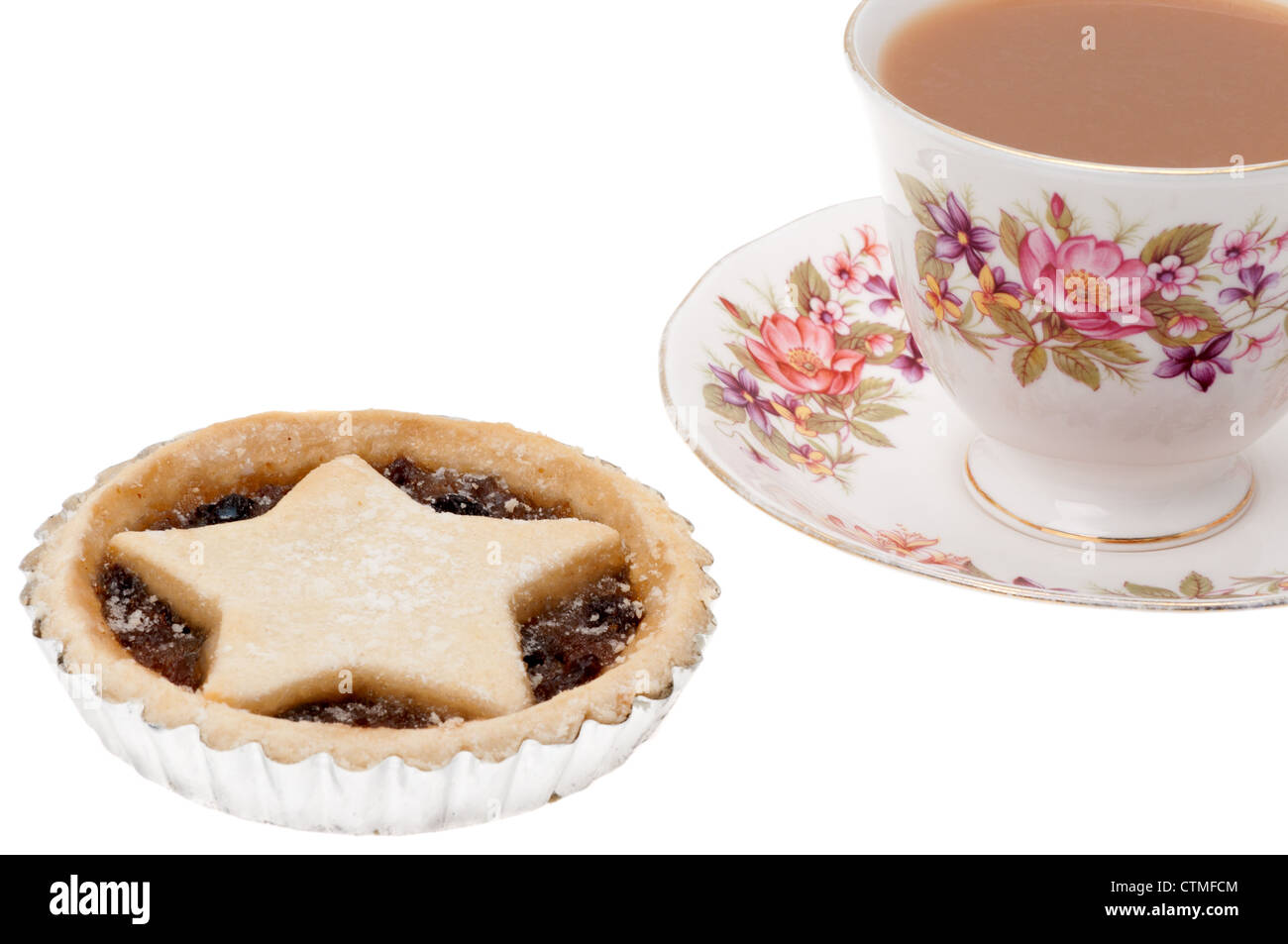 A single festive or Christmas mince pie with a cup of tea served in an