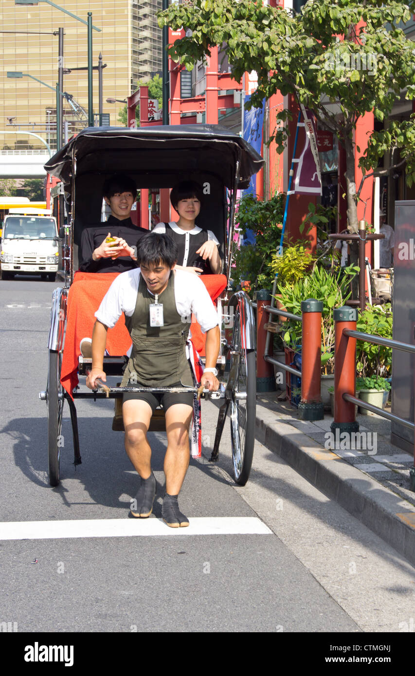 A foot rickshaw in operation for tourists in Tokyo Japan Stock Photo