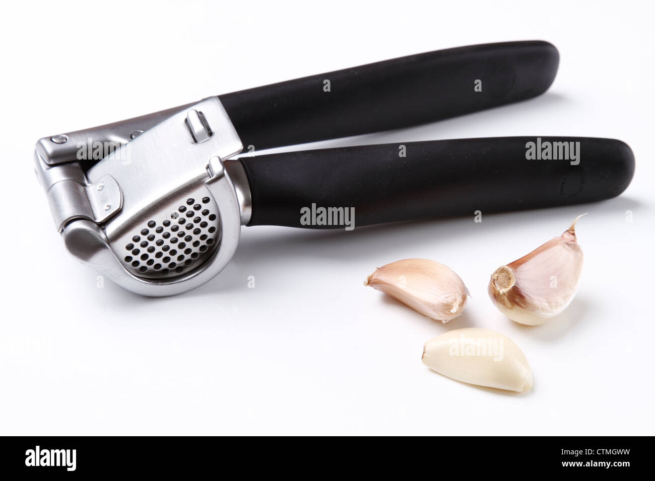 Garlic press and garlic Stock Photo Alamy