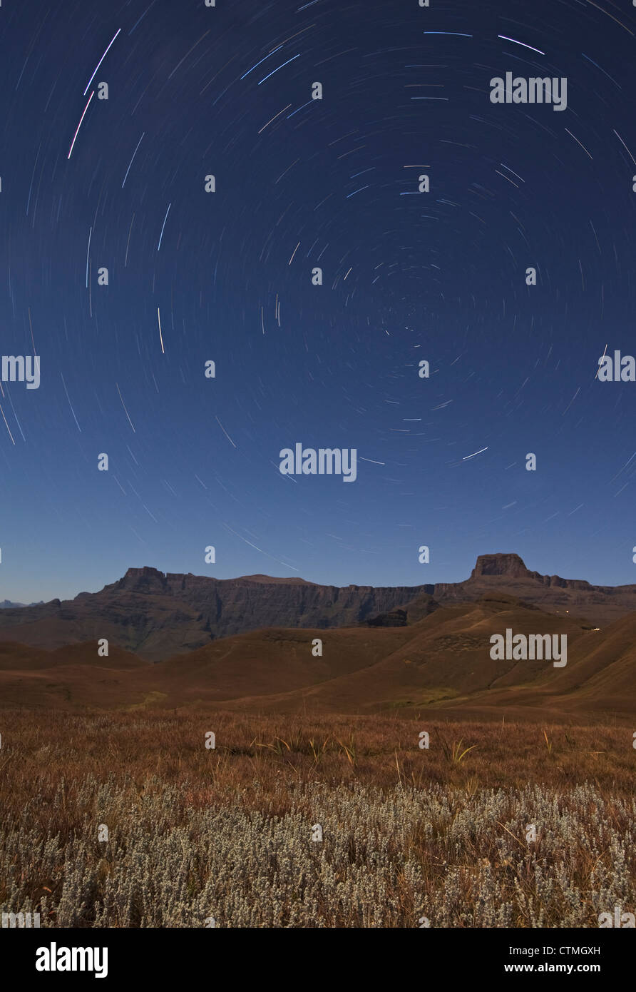 Star trails over the Amphitheatre range in the Drakensberg mountains, Kwazulu-Natal, South Africa Stock Photo
