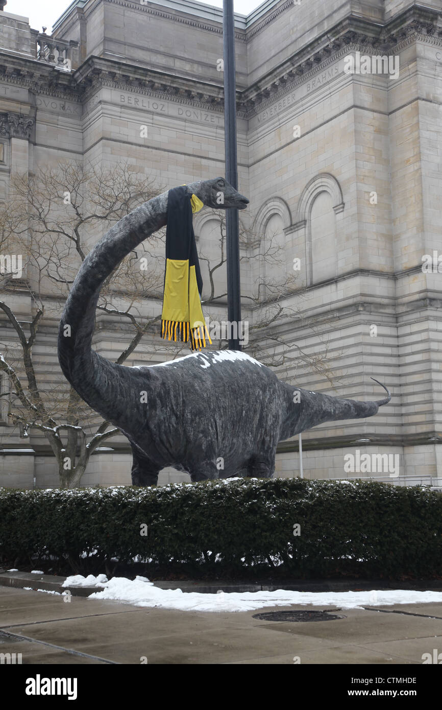 Carnegie Concert Hall Pittsburgh with dinosaur statue wearing a 'Pittsburgh Steelers' black and gold scarf Stock Photo