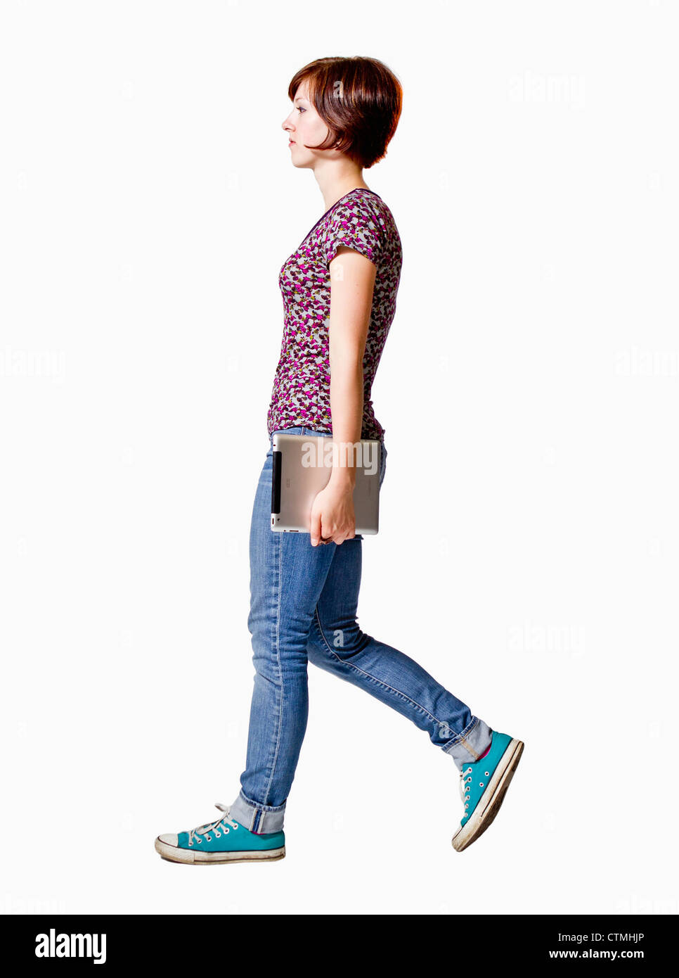 Young Woman Walking With A Tablet Computer In Her Hand Stock Photo