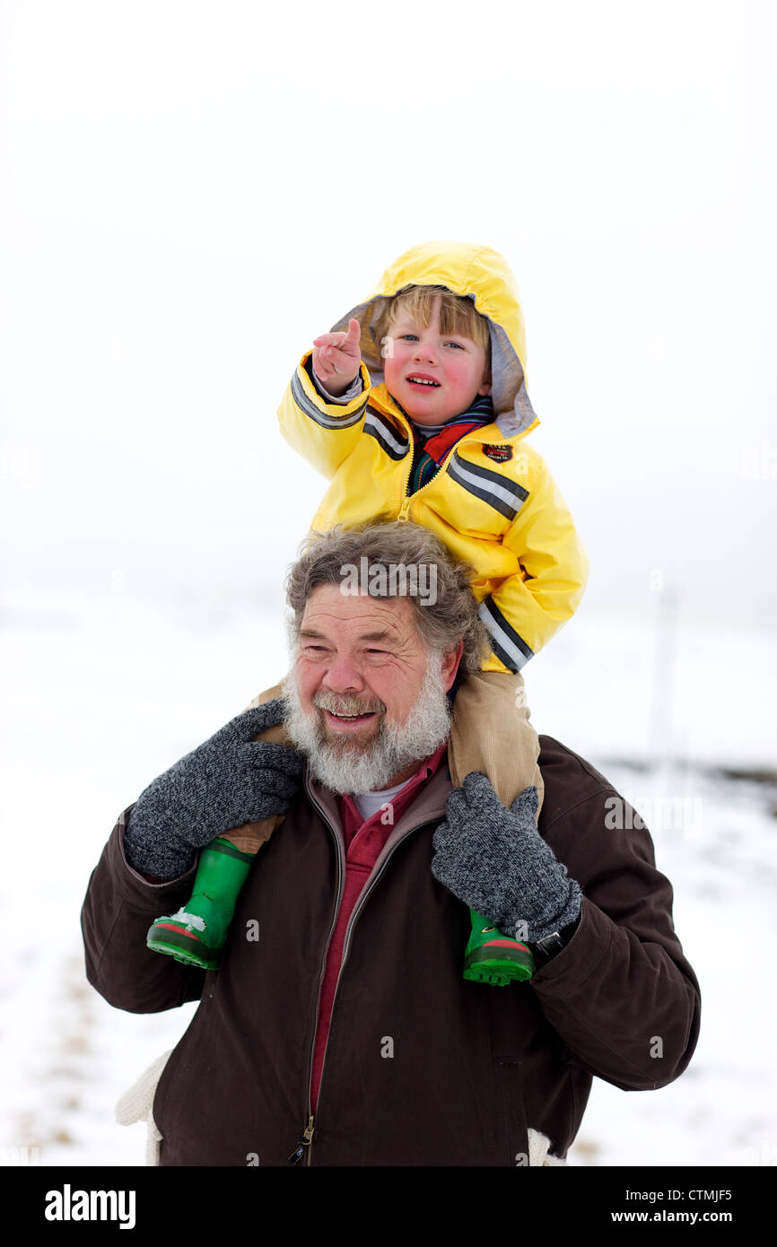A portrait of a grandfather carrying his grandson on his sholders