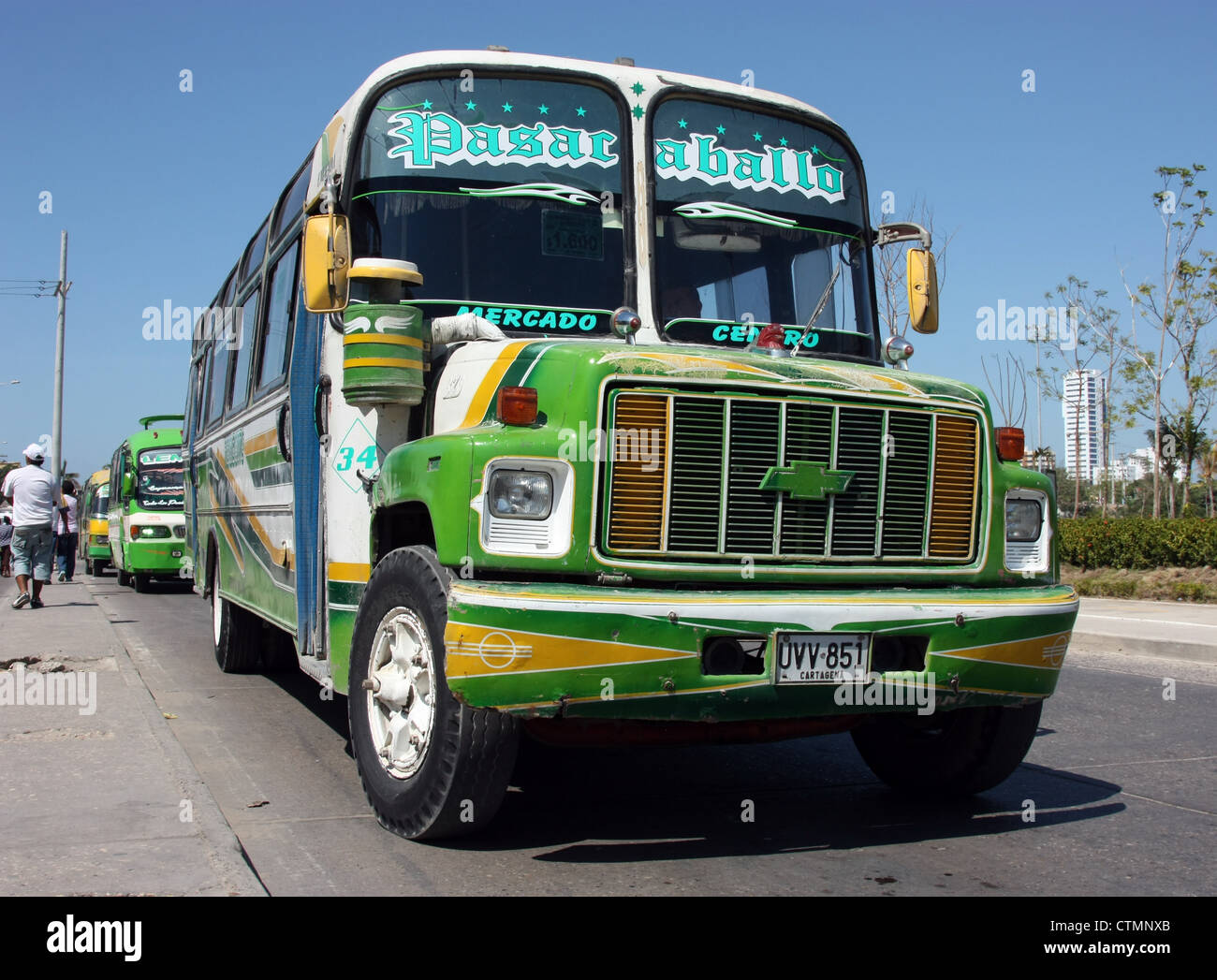Brightly decorated local bus (chicken bus) picking up passengers in Old City Cartagena Colombia South America Stock Photo
