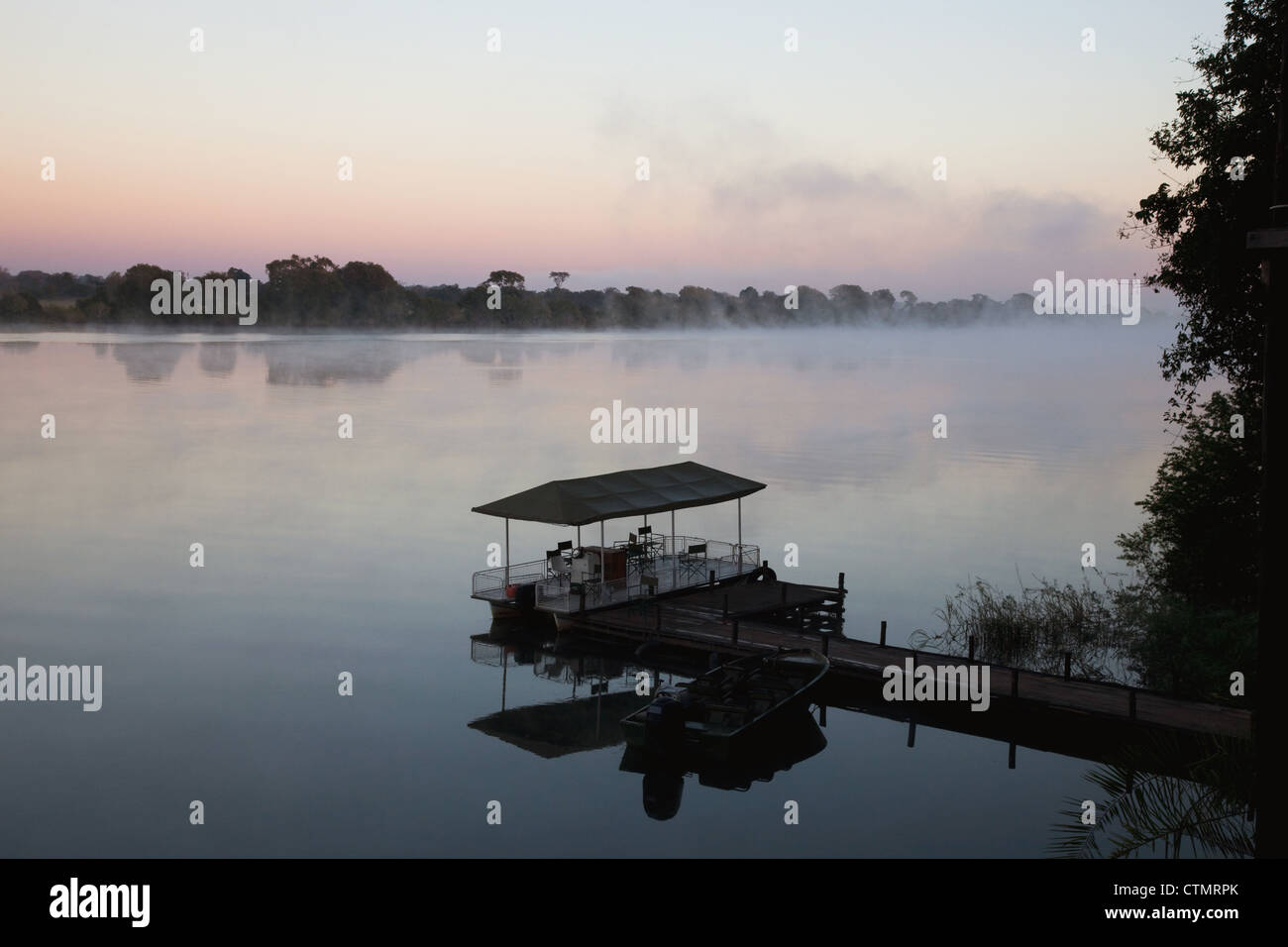 Game viewing boat on Kafue River at sunrise, Kafue National Park, Zambia, Africa Stock Photo