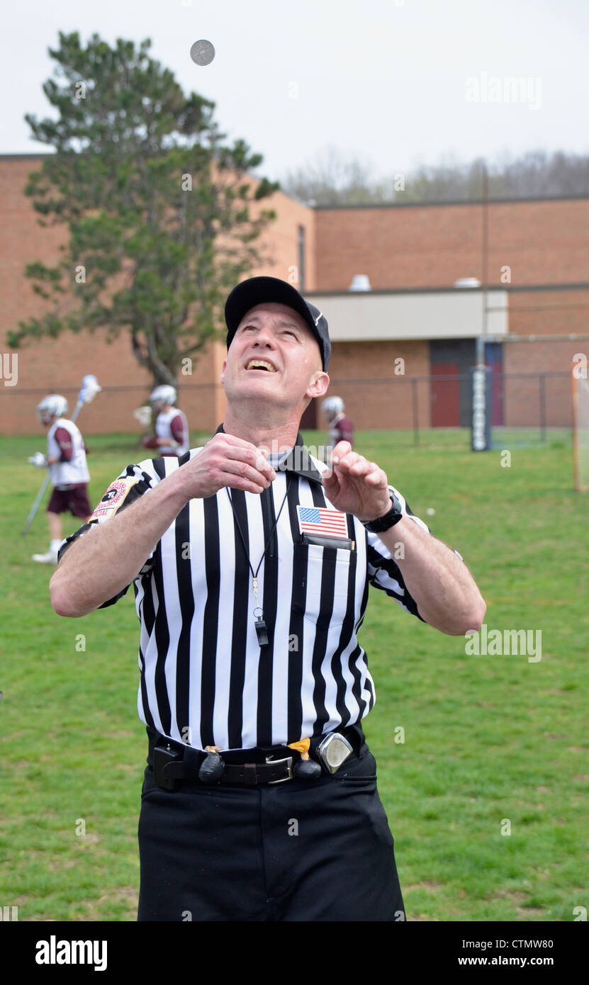 Referee flips coin at start of a lacrosse game Stock Photo Alamy
