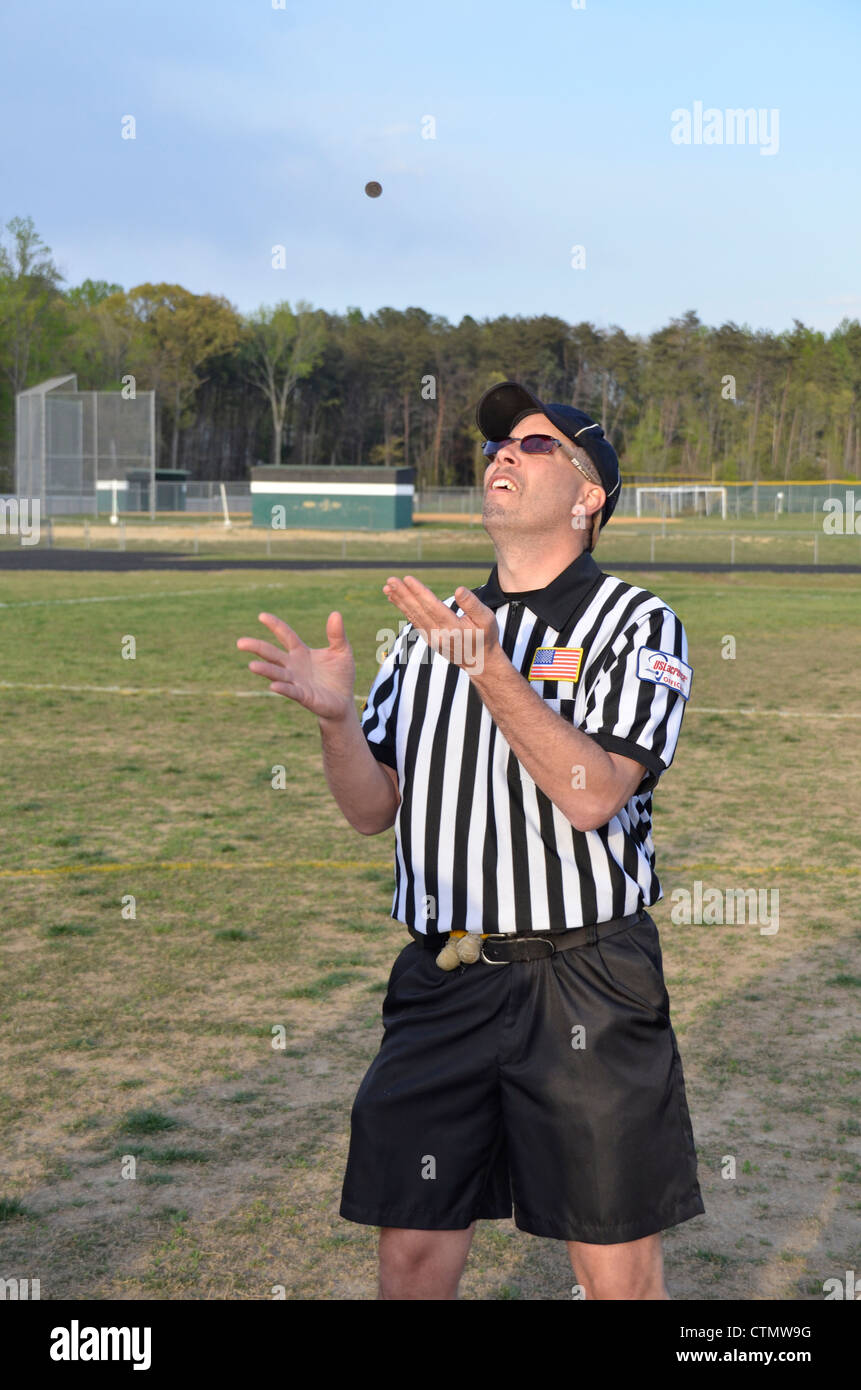 Referee flips coin at start of a lacrosse game Stock Photo Alamy