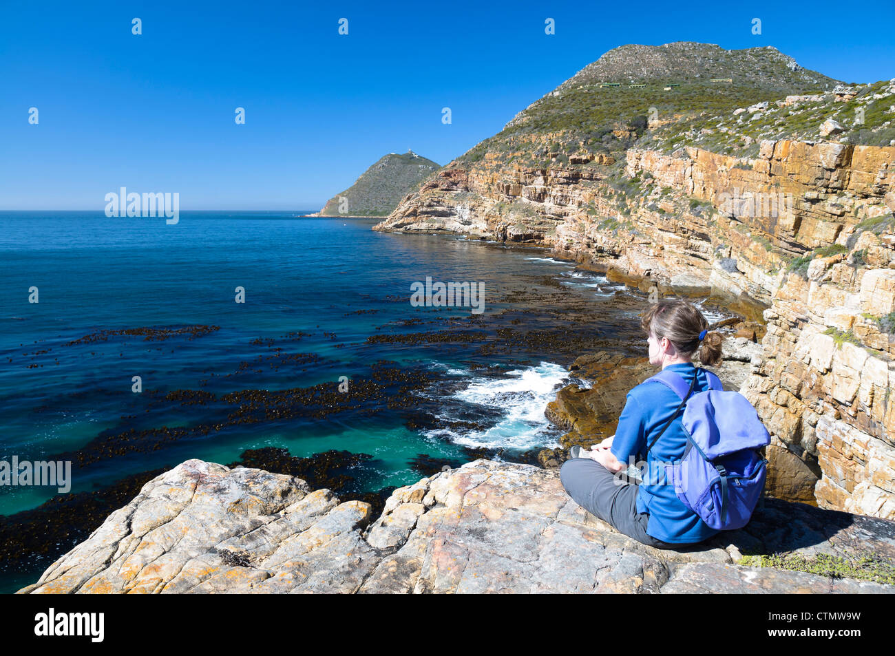 Woman sitting rocky cliff hi-res stock photography and images - Alamy